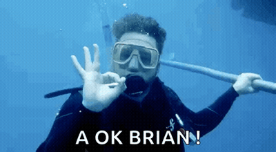 A Man In A Scuba Suit Is Giving An Ok Sign In The Water GIF
