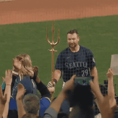 A Man In A Seattle Jersey Stands In Front Of A Crowd GIF
