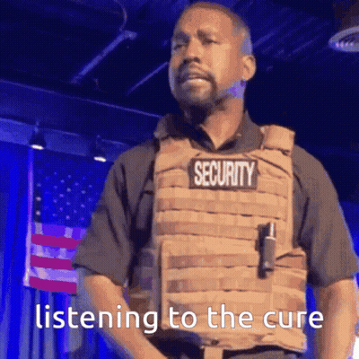 A Man In A Security Vest Is Listening To The Cure . GIF