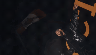 A Man In A Sequined Jacket Is Dancing In Front Of A Large Number 15 GIF