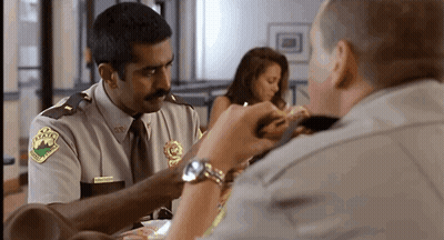 A Man In A Sheriff 'S Uniform Has A Patch On His Shoulder That Says ' Texas ' On It GIF