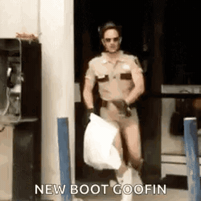 A Man In A Sheriff 'S Uniform Is Carrying A Bag Of Trash . GIF