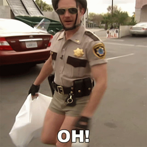 A Man In A Sheriff 'S Uniform Is Kneeling Down And Holding A White Bag With The Words Oh Written On It GIF