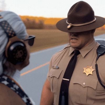 A Man In A Sheriff 'S Uniform Is Talking To Another Man GIF