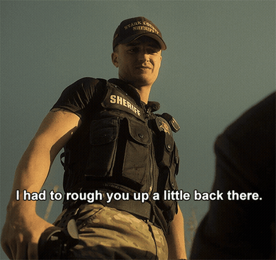 A Man In A Sheriff Uniform Says " I Had To Rough You Up A Little Back There .. " GIF