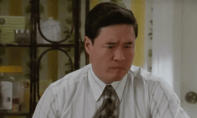 A Man In A Shirt And Tie Is Making A Funny Face . GIF