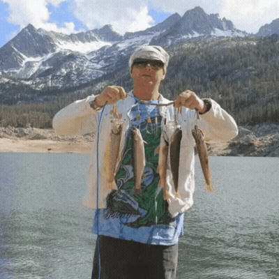 A Man In A Shirt That Says ' Jellyfish ' On It Is Holding A String Of Fish GIF
