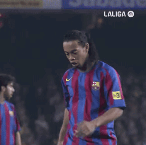 A Man In A Siemens Shirt Stands Next To Another Man In An Adidas Shirt GIF