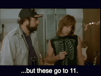 A Man In A Skeleton Shirt Is Talking To Another Man In A Hat ..But These Go To 11 . GIF
