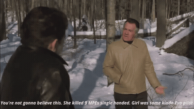 A Man In A Snowy Forest Talking To Another Man GIF