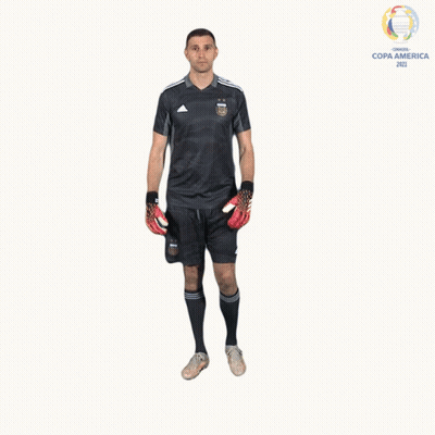 A Man In A Soccer Uniform Is Holding A Pair Of Gloves In Front Of A Copa America Logo GIF