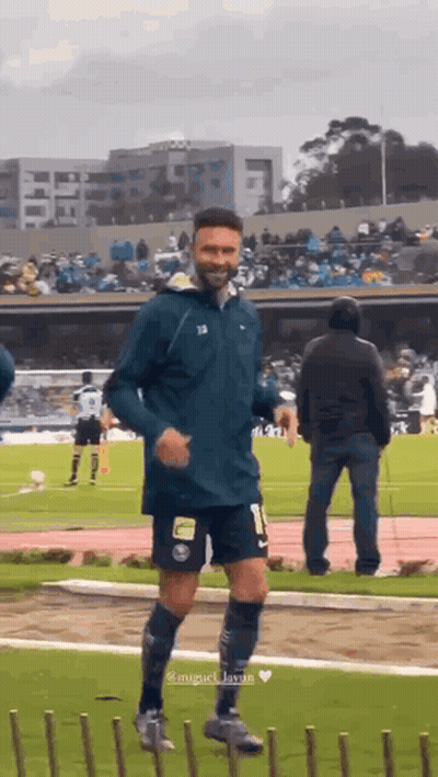 A Man In A Soccer Uniform Is Running On A Field GIF