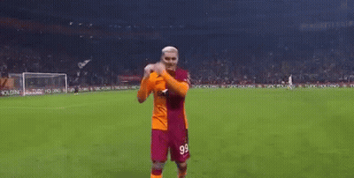 A Man In A Soccer Uniform Is Standing On A Soccer Field . GIF
