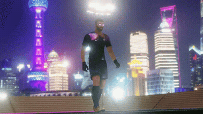 A Man In A Soccer Uniform Is Walking In Front Of A City Skyline At Night GIF
