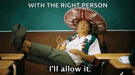 A Man In A Sombrero Is Sitting At A Desk In A Classroom With His Feet Up . GIF