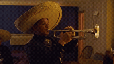 A Man In A Sombrero Plays A Trumpet GIF