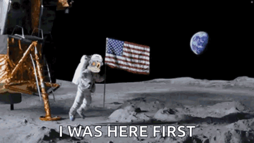 A Man In A Space Suit Is Walking On The Moon . GIF