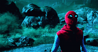 A Man In A Spider Man Costume Is Standing In A Dark Area GIF