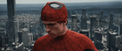 A Man In A Spider Man Costume Stands In Front Of A City Skyline GIF