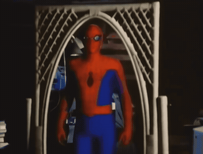 A Man In A Spider Man Costume Stands In Front Of A White Archway GIF
