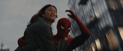 A Man In A Spiderman Costume Is Carrying A Woman GIF