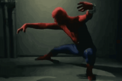 A Man In A Spiderman Costume Is Crawling On The Ground GIF