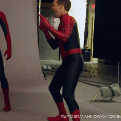 A Man In A Spiderman Costume Is Dancing In A Room GIF
