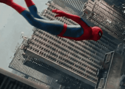 A Man In A Spiderman Costume Is Flying Through The Air Over A City GIF