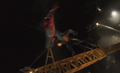 A Man In A Spiderman Costume Is Flying Through The Air GIF