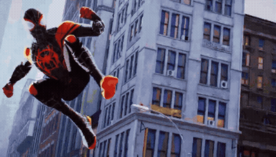 A Man In A Spiderman Costume Is Jumping Through The Air GIF