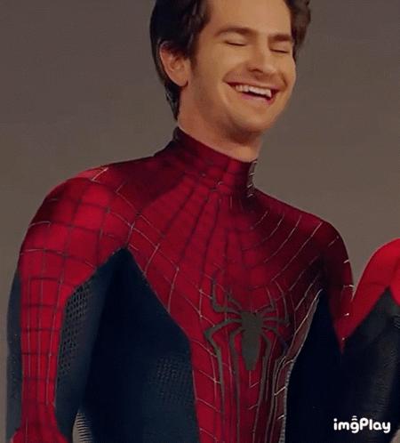 A Man In A Spiderman Costume Is Looking At The Camera GIF