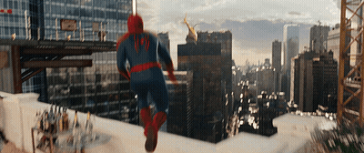 A Man In A Spiderman Costume Is Running On A Rooftop GIF