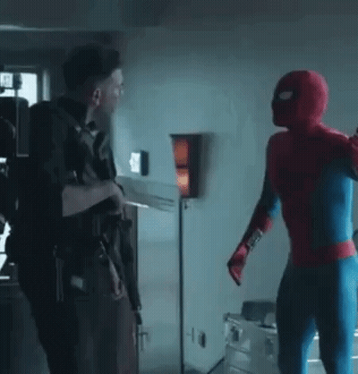 A Man In A Spiderman Costume Is Standing Next To Another Man In A Spiderman Costume . GIF