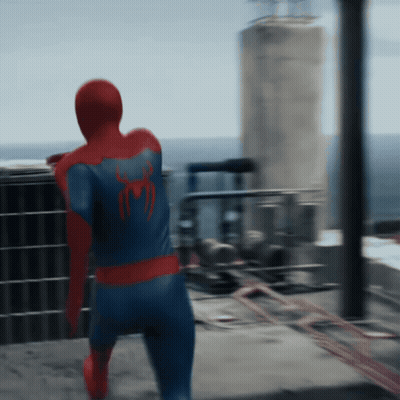 A Man In A Spiderman Costume Is Standing On A Balcony GIF