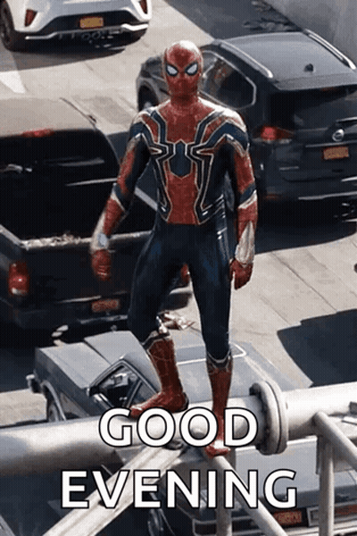 a man in a spiderman costume is standing on top of a metal pipe .