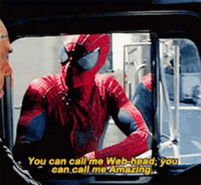 A Man In A Spiderman Costume Is Talking To Another Man . GIF