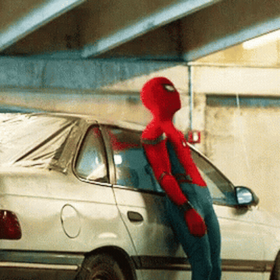 A Man In A Spiderman Costume Leans Against A White Car GIF