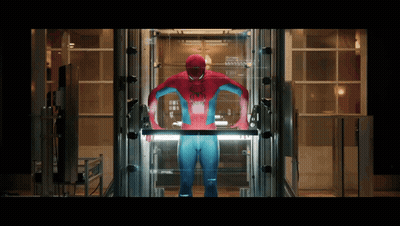 A Man In A Spiderman Costume Stands In An Elevator GIF