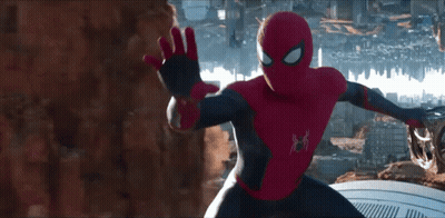 A Man In A Spiderman Costume Stands In Front Of A City Skyline GIF