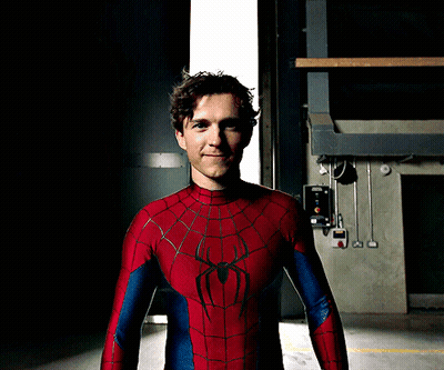 A Man In A Spiderman Costume Stands In Front Of A Door GIF