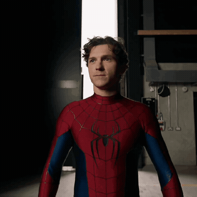 A Man In A Spiderman Costume Stands In Front Of A Door GIF