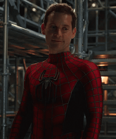 A Man In A Spiderman Costume Stands In Front Of Scaffolding GIF
