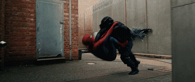 A Man In A Spiderman Suit Is Being Lifted In The Air By Another Man GIF