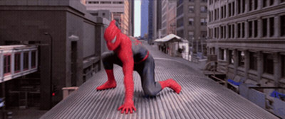 A Man In A Spiderman Suit Is Crawling On A Roof GIF