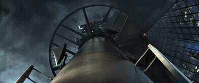A Man In A Spiderman Suit Is Fighting A Dinosaur GIF