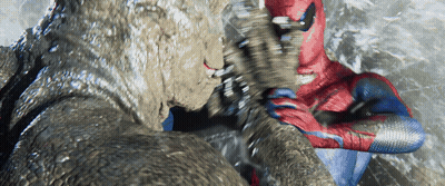 A Man In A Spiderman Suit Is Fighting A Giant Monster GIF