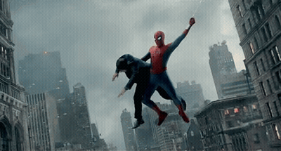 A Man In A Spiderman Suit Is Flying Through The Air GIF