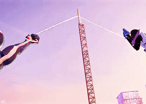 A Man In A Spiderman Suit Is Flying Through The Air GIF