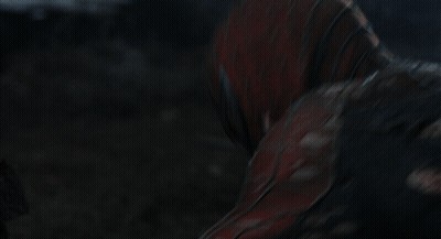 A Man In A Spiderman Suit Is Holding A Spider Web In His Hand GIF