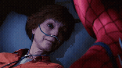 A Man In A Spiderman Suit Is Laying In A Hospital Bed GIF